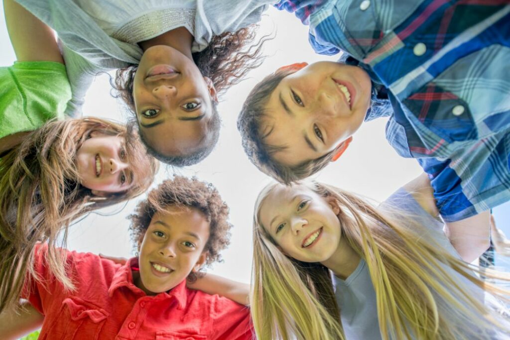 Un groupe d'enfants qui prends une photo en contre plongée.